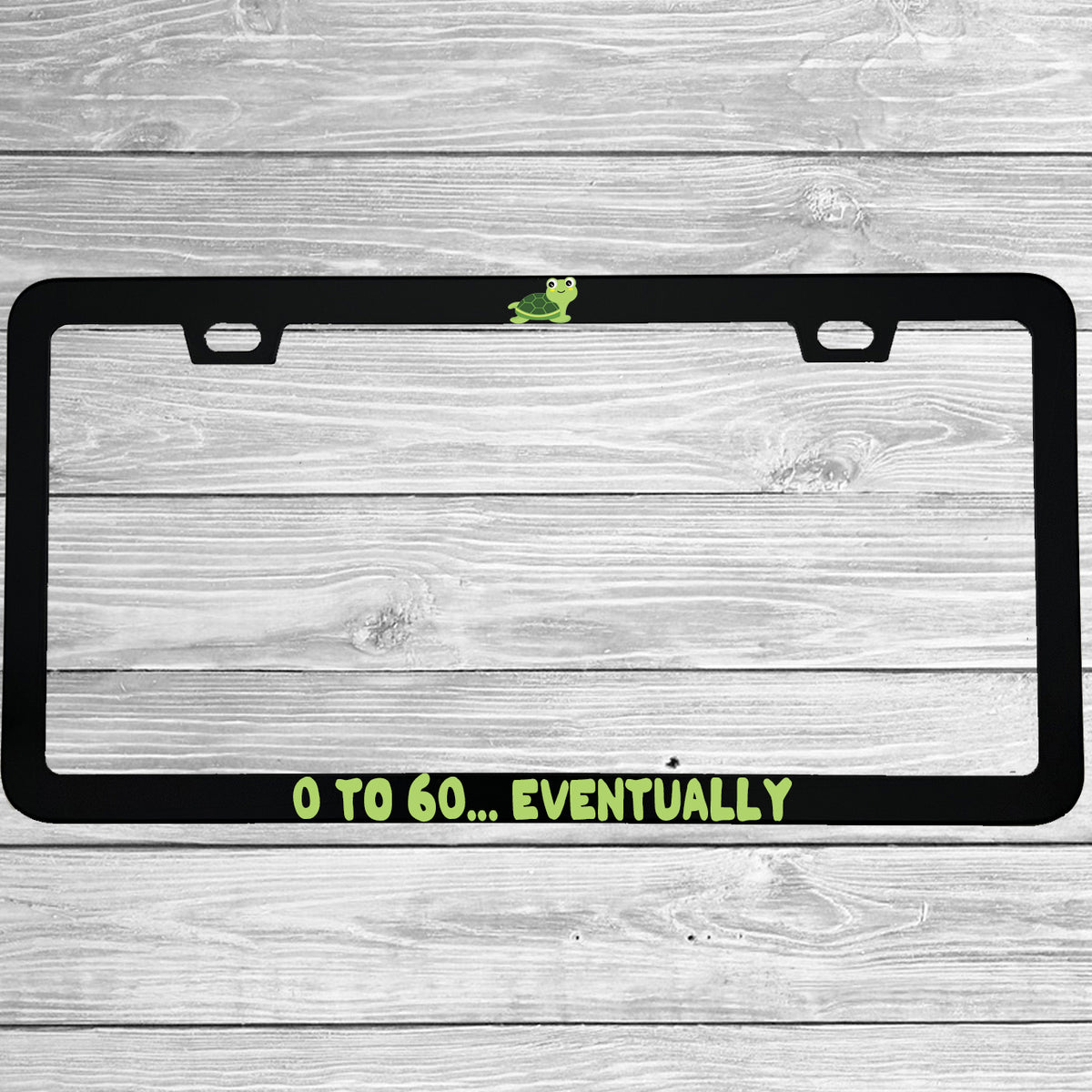 Close-up of "0 To 60 Eventually" license plate frame showing fade-proof print quality