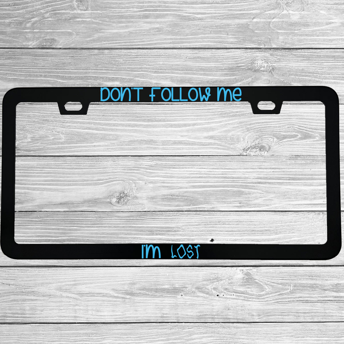Close-up of "Don't Follow Me I'm Lost" license plate frame showing fade-proof print quality