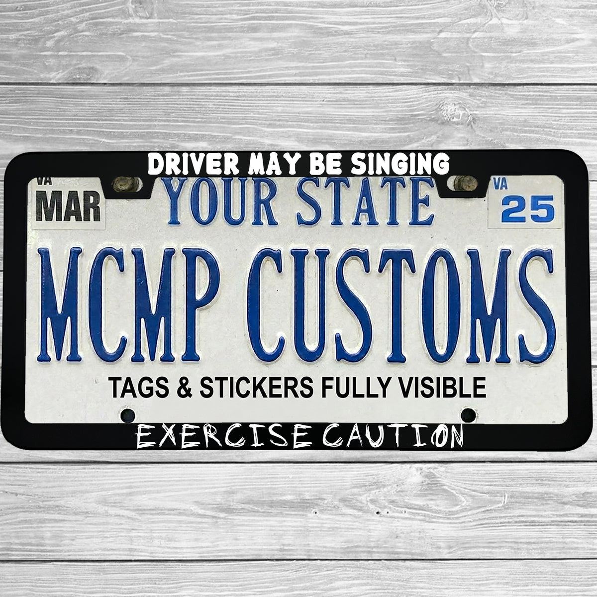 "Driver May Be Singing Exercise Caution" license plate frame shown on vehicle β lifestyle photo
