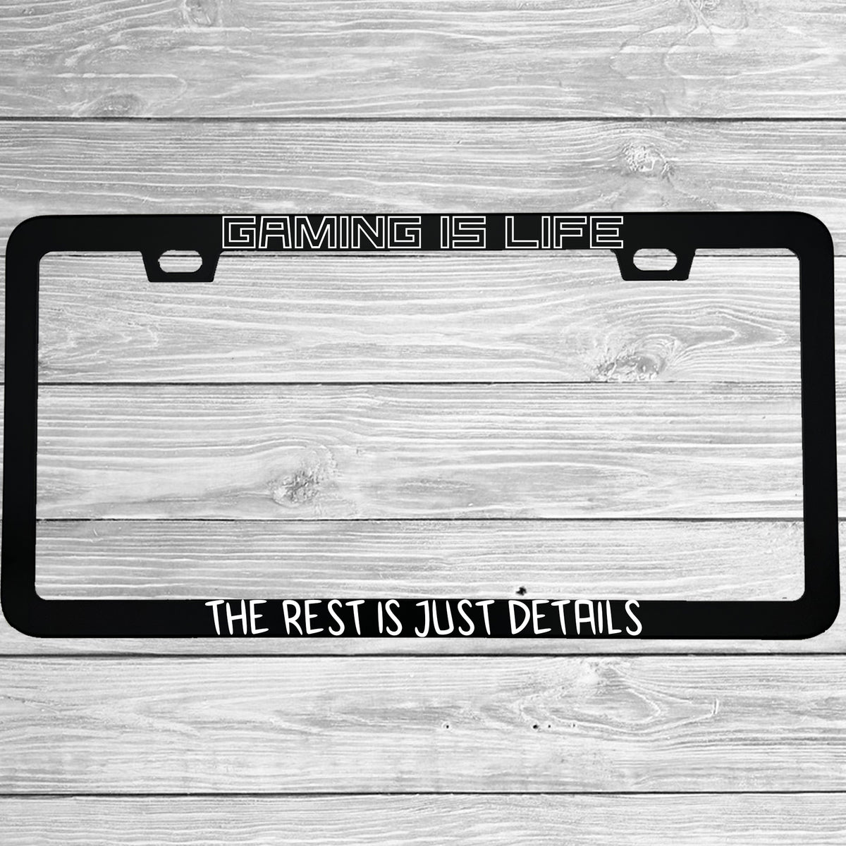 Close-up of "Gaming Is Life The Rest Is Just Details" license plate frame showing fade-proof print quality