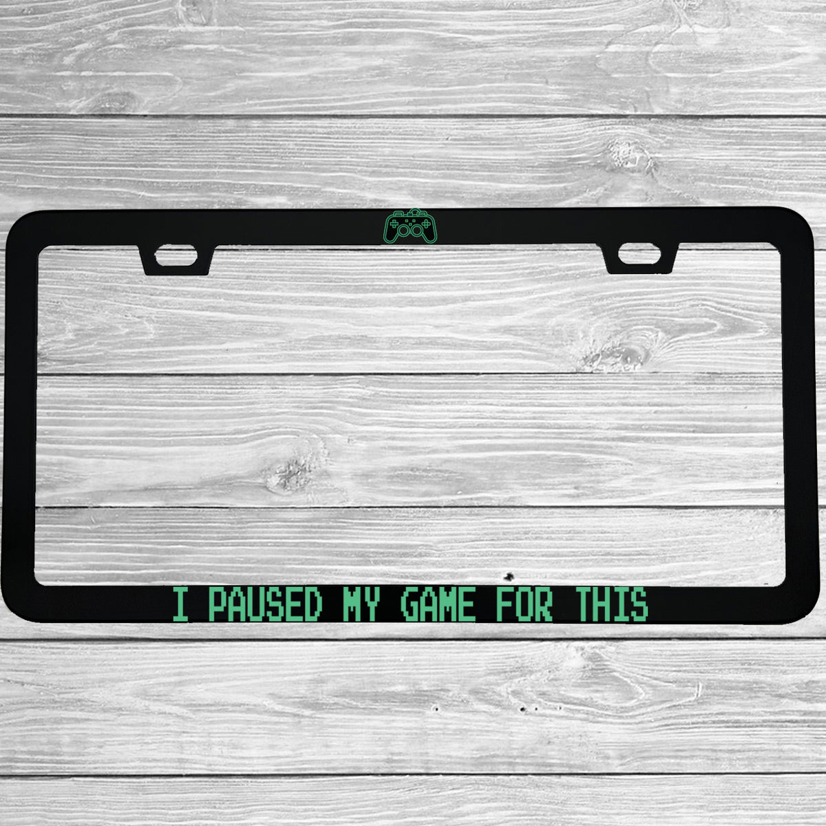 Close-up of "I Paused My Game For This" license plate frame showing fade-proof print quality