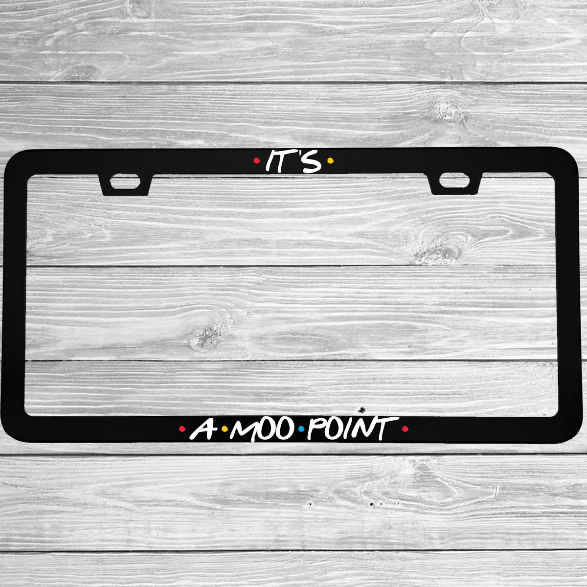 Close-up of "Its A Moo Point" license plate frame showing fade-proof print quality