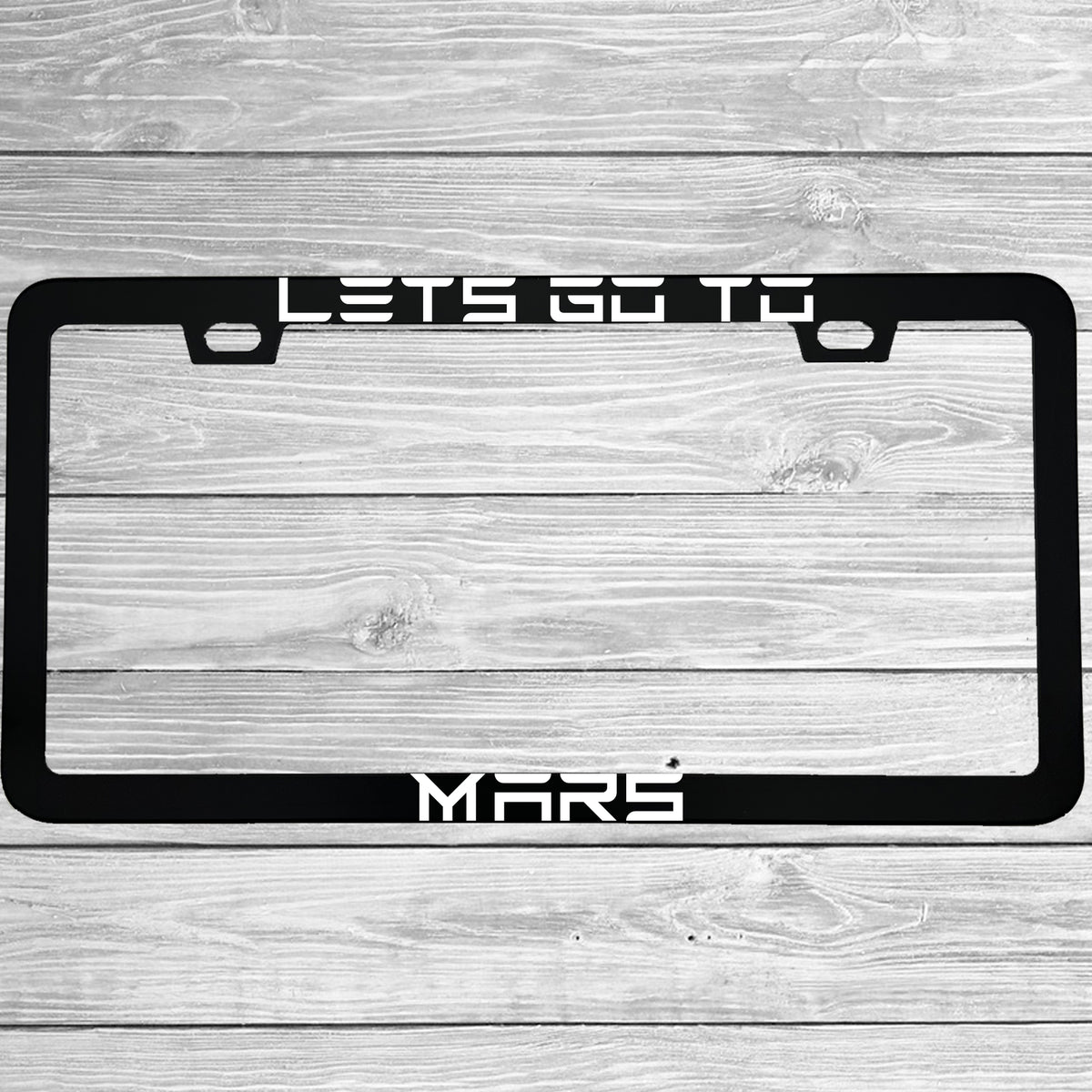 Close-up of "Lets Go To Mars Funny Electric Car Outer Space" license plate frame showing fade-proof print quality