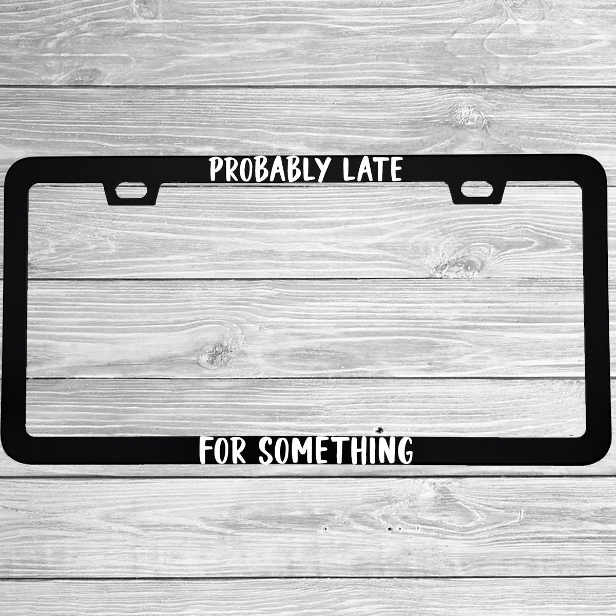 Close-up of "Probably Late For Something" license plate frame showing fade-proof print quality
