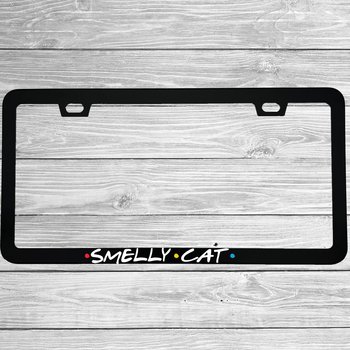 Close-up of "Smelly Cat" license plate frame showing fade-proof print quality