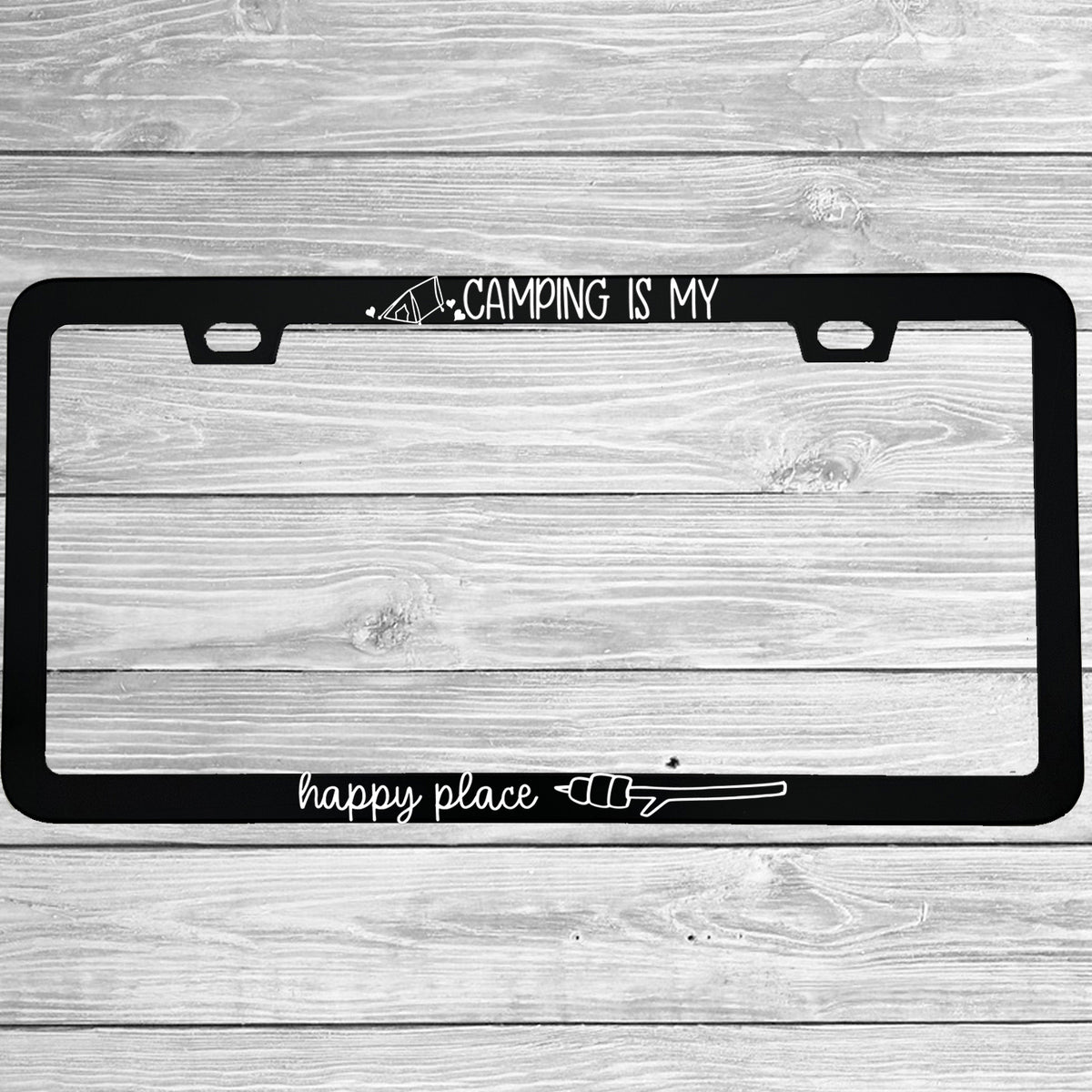 "Camping Is My Happy Place" license plate frame shown on vehicle — lifestyle photo
