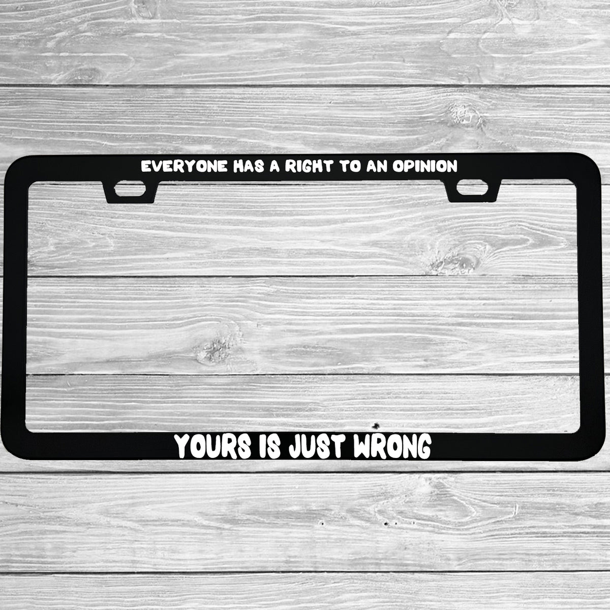 Close-up of "Everyone Has A Right To An Opinion Yours Is Just Wrong" license plate frame showing fade-proof print quality