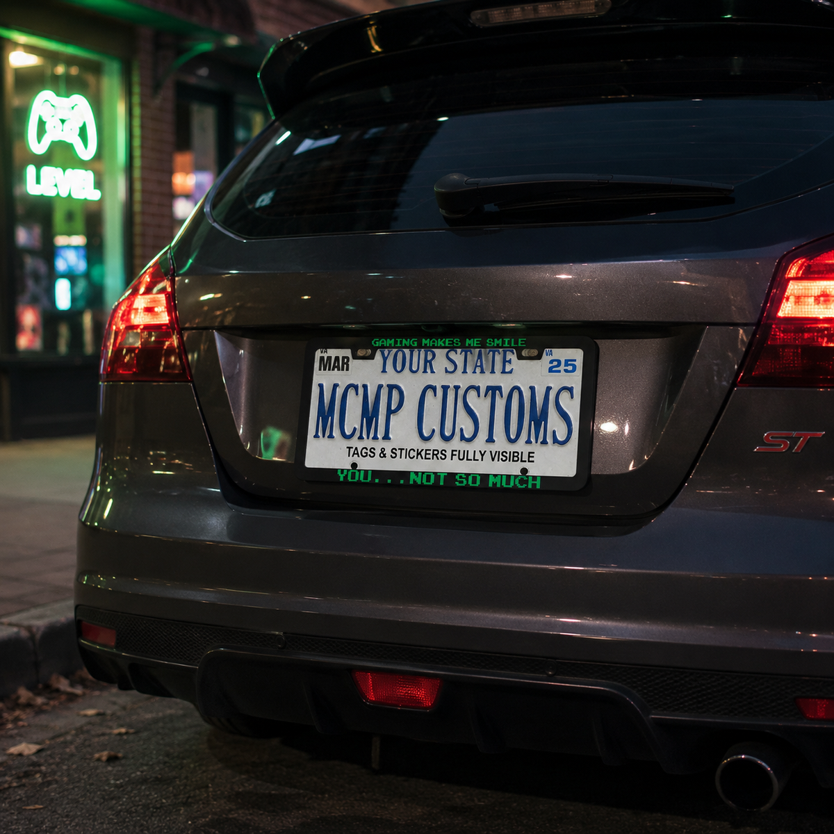 "Gaming Makes Me Smile, You Not So Much" license plate frame shown on vehicle — lifestyle photo