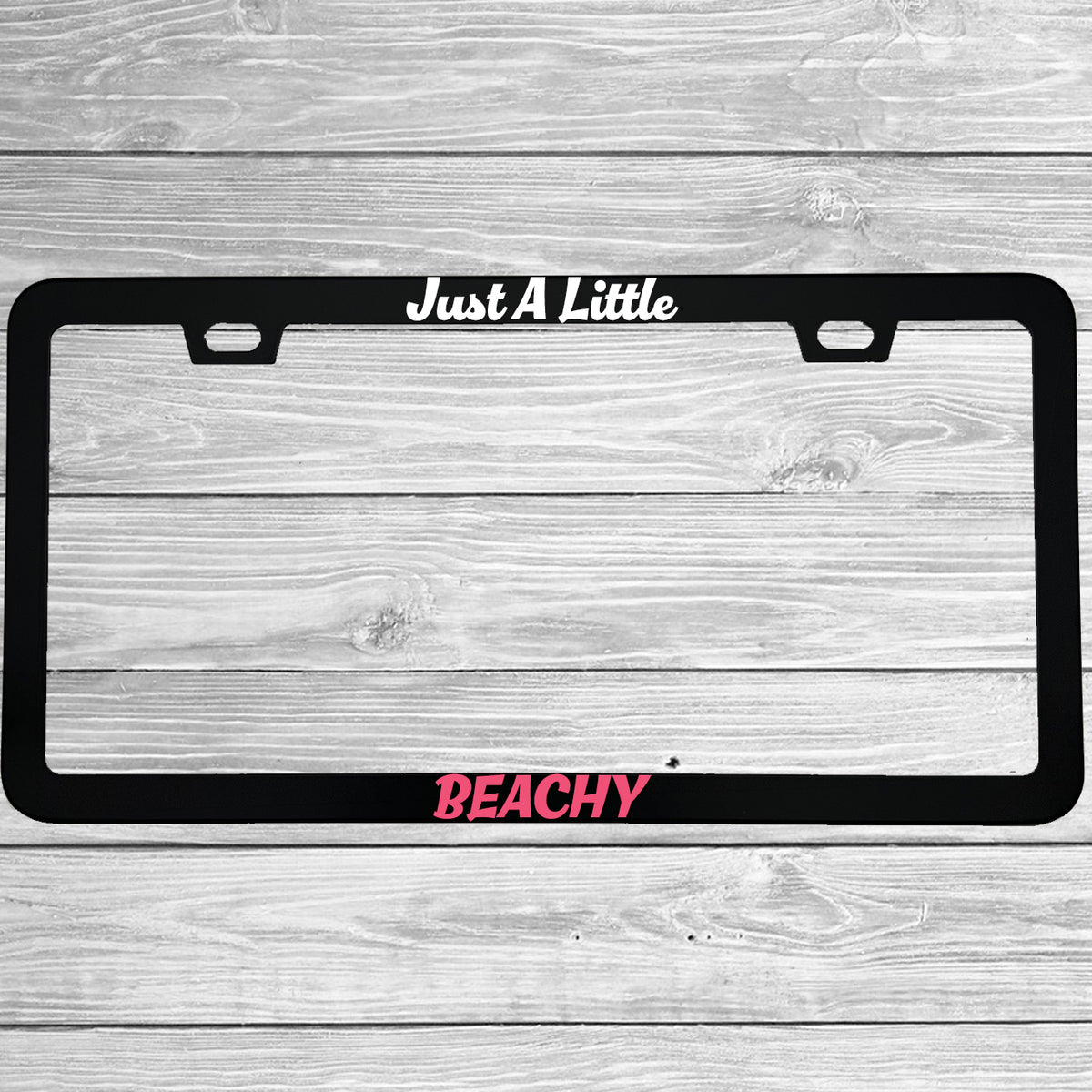 Close-up of "Just A Little Beachy" license plate frame showing fade-proof print quality