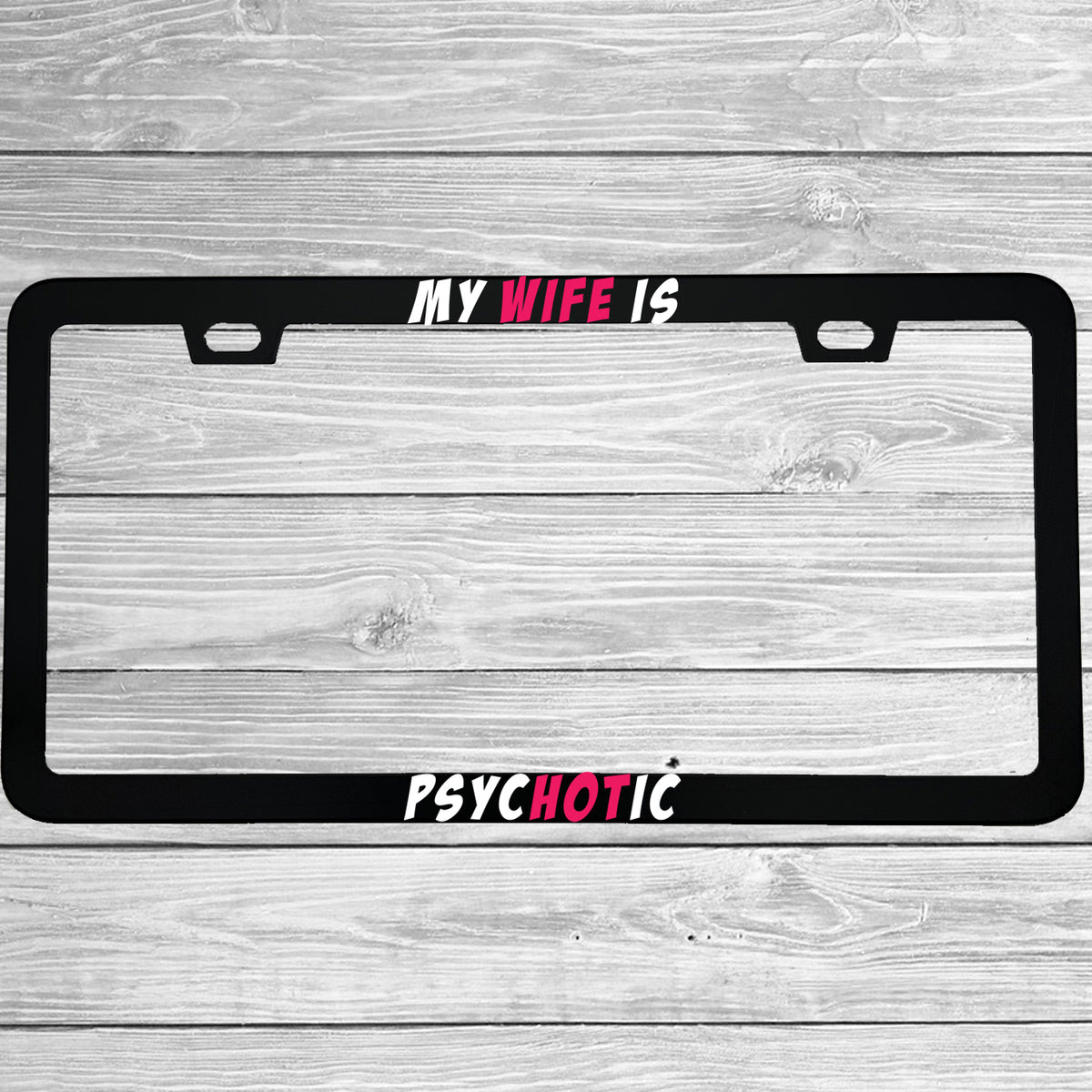 Close-up of "My Wife Is Psychotic" license plate frame showing fade-proof print quality