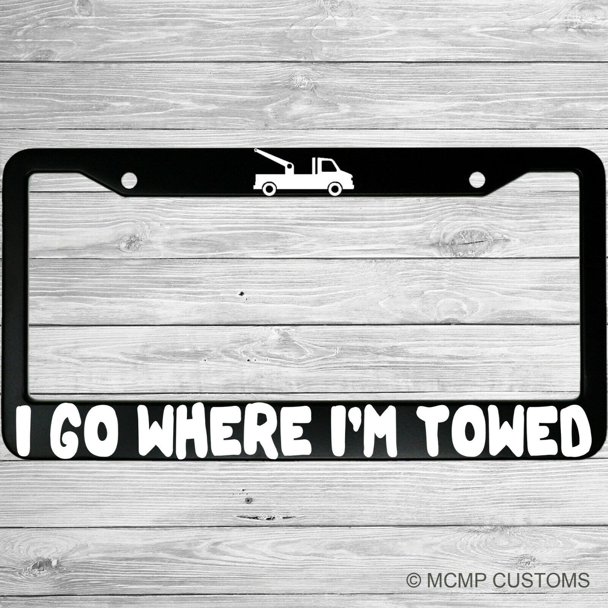 "I Go Where I'm Towed" license plate frame shown on vehicle — lifestyle photo