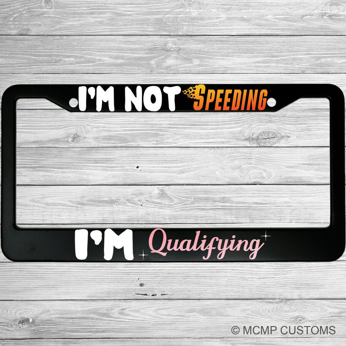"I'm Not Speeding, I'm Qualifying" license plate frame shown on vehicle — lifestyle photo
