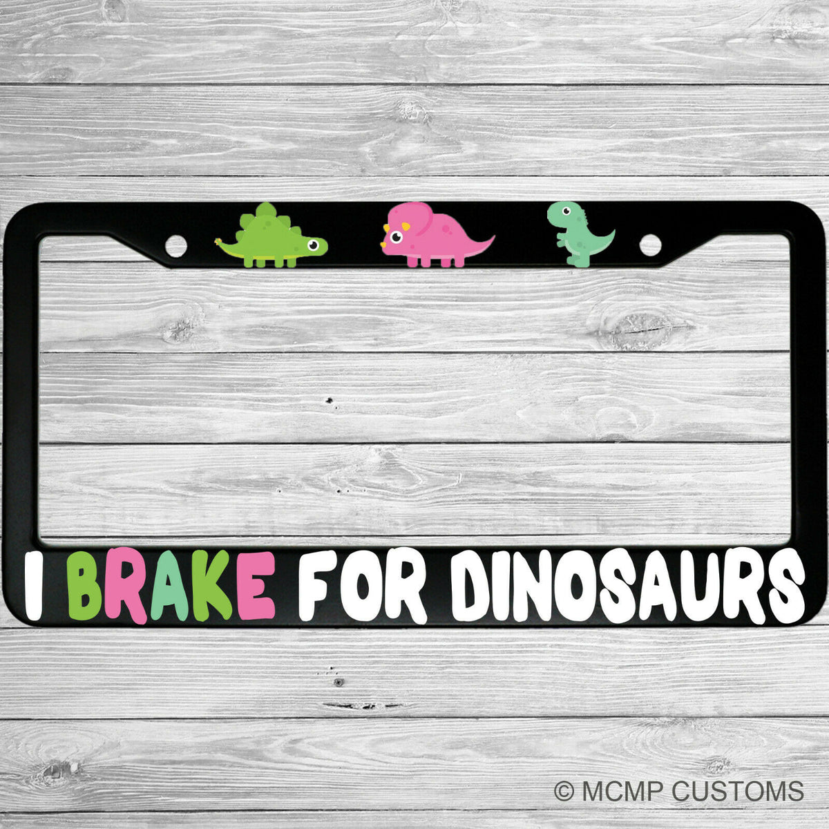 "I Brake For Dinosaurs" license plate frame shown on vehicle — lifestyle photo