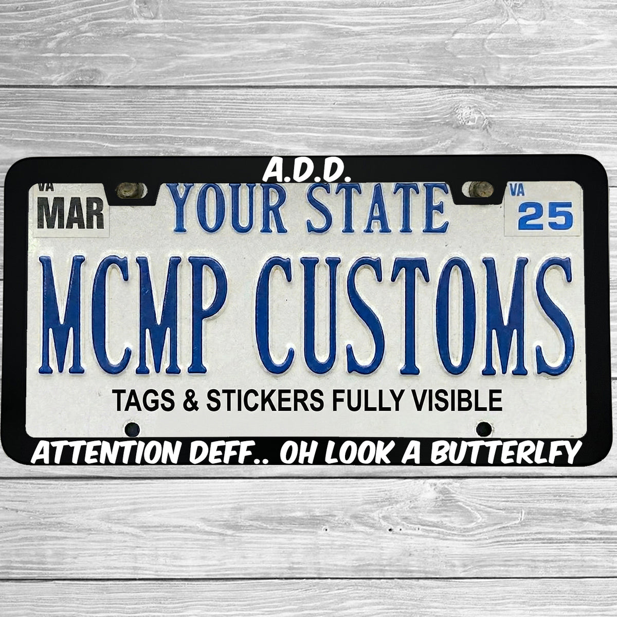 "ADD Attention Def Oh Look A Butterfly" license plate frame shown on vehicle — lifestyle photo