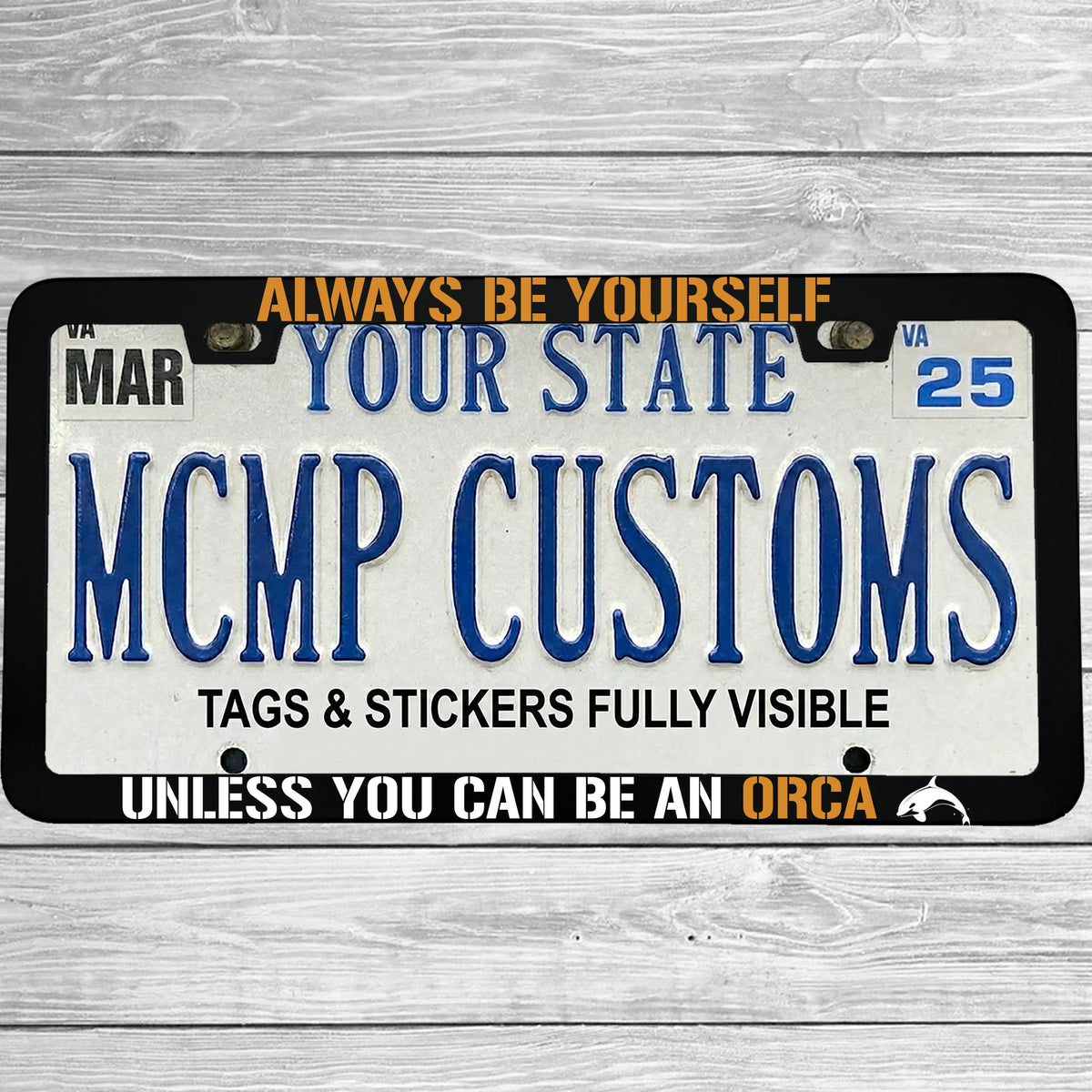 "Always Be Yourself Unless You Can Be An Orca" license plate frame shown on vehicle — lifestyle photo