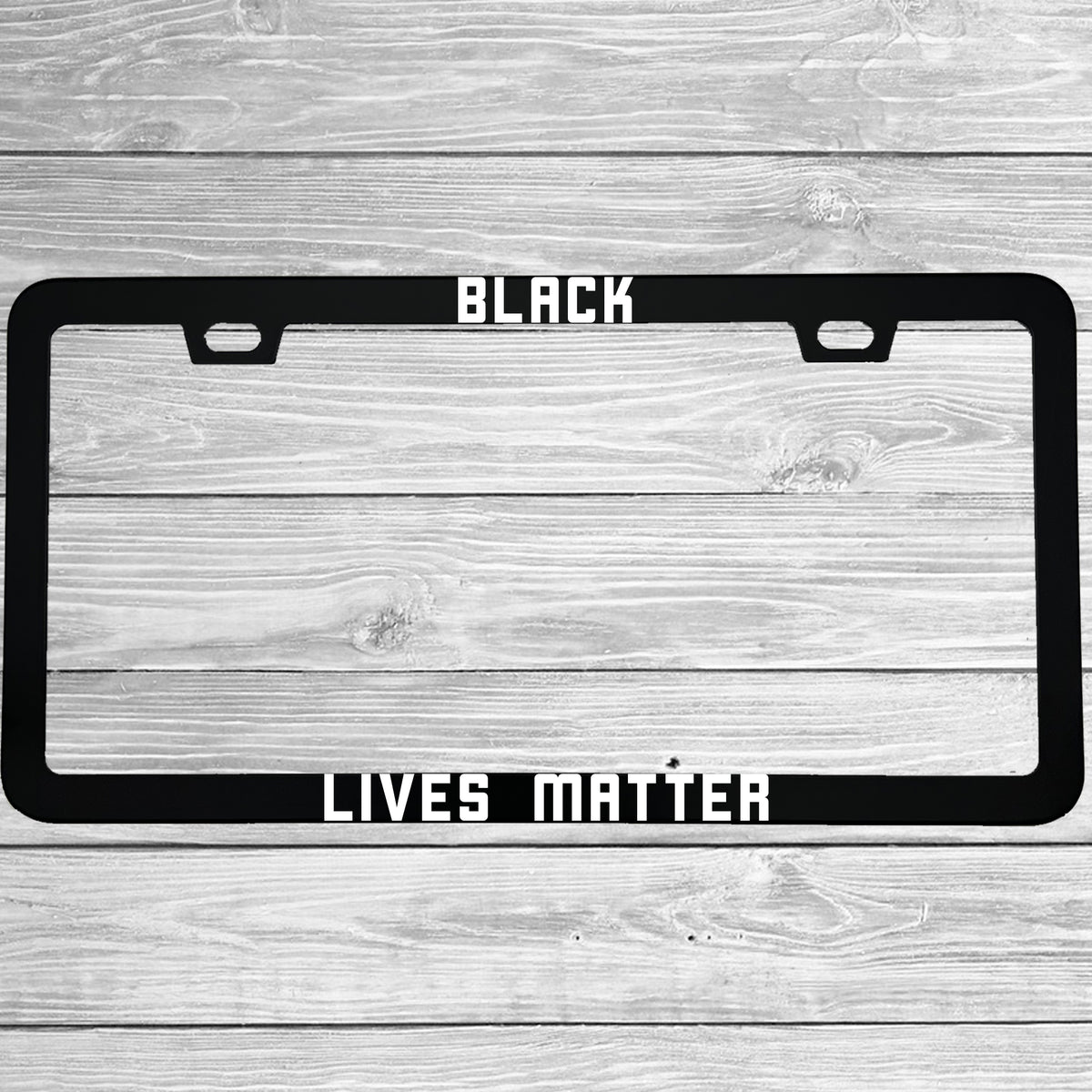 Close-up of "Black Lives Matter" license plate frame showing fade-proof print quality