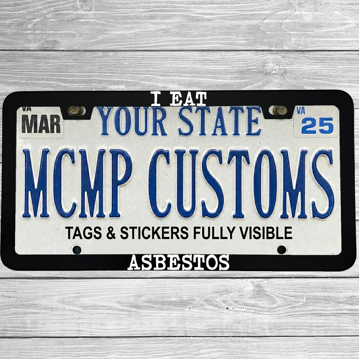 "I Eat Asbestos" license plate frame shown on vehicle — lifestyle photo