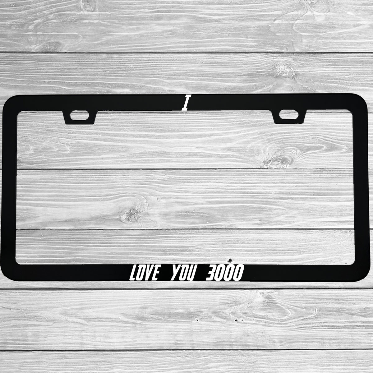 Close-up of "I Love You 3000" license plate frame showing fade-proof print quality