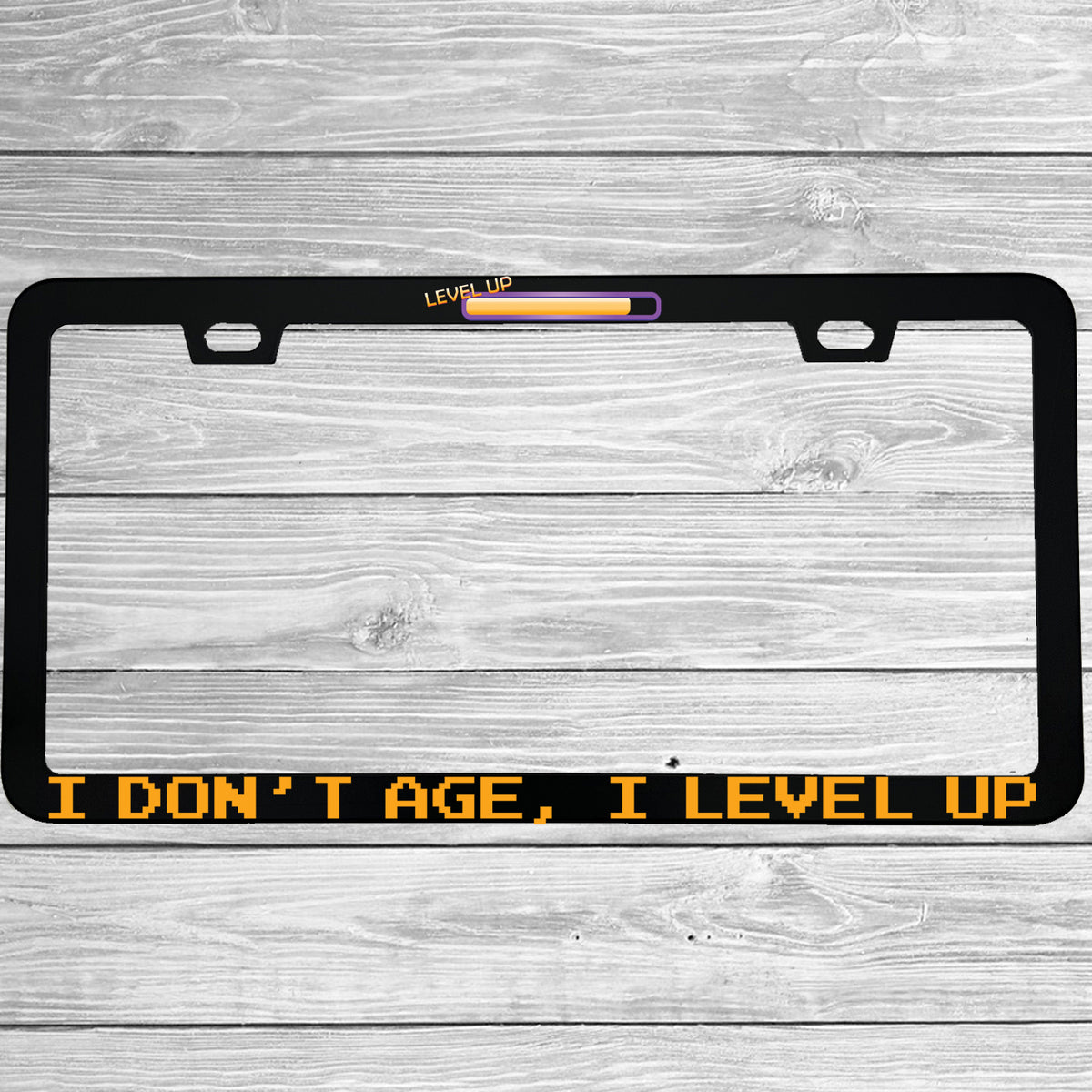 Close-up of "I Dont Age I Level Up" license plate frame showing fade-proof print quality