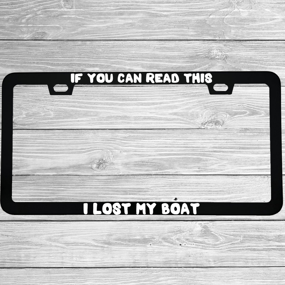 Close-up of "If You Can Read This I Lost My Boat" license plate frame showing fade-proof print quality