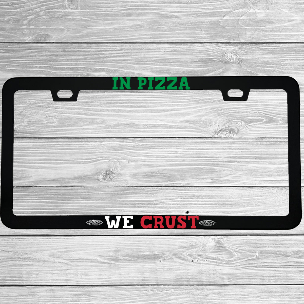 Close-up of "In Pizza We Crust" license plate frame showing fade-proof print quality