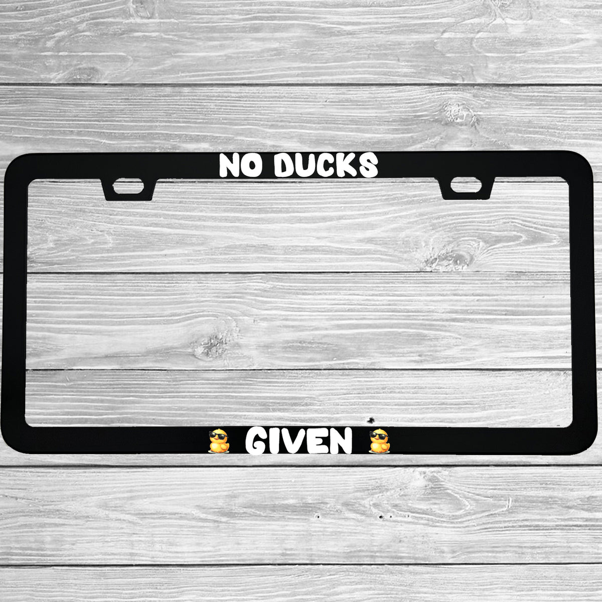 Close-up of "No Ducks Given" license plate frame showing fade-proof print quality