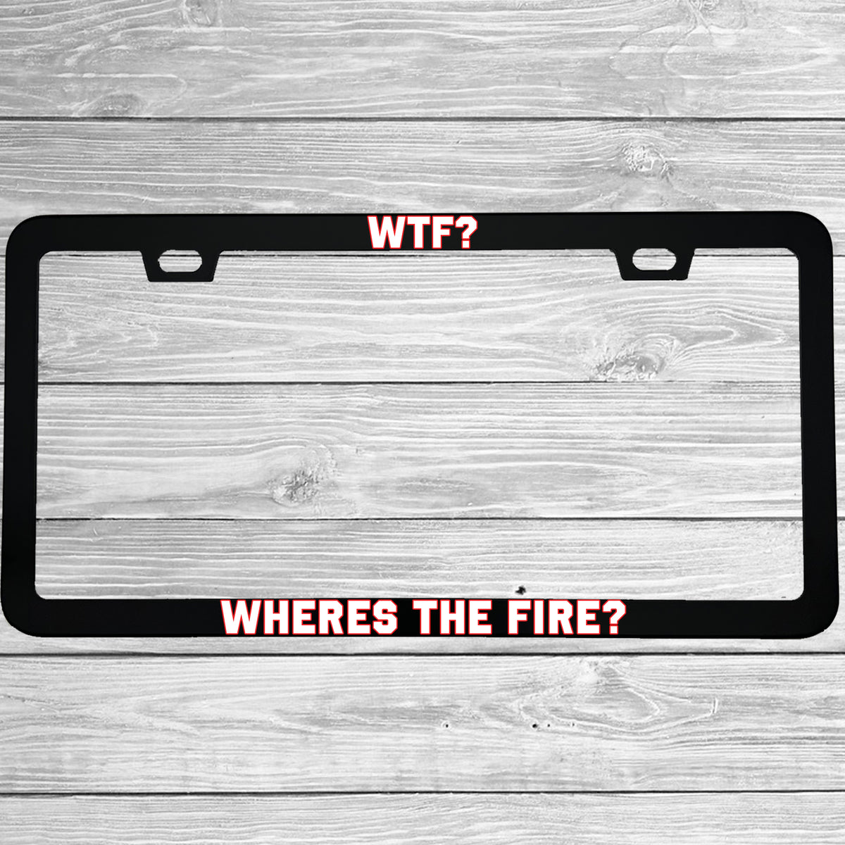 Close-up of "WTF Wheres The Fire" license plate frame showing fade-proof print quality