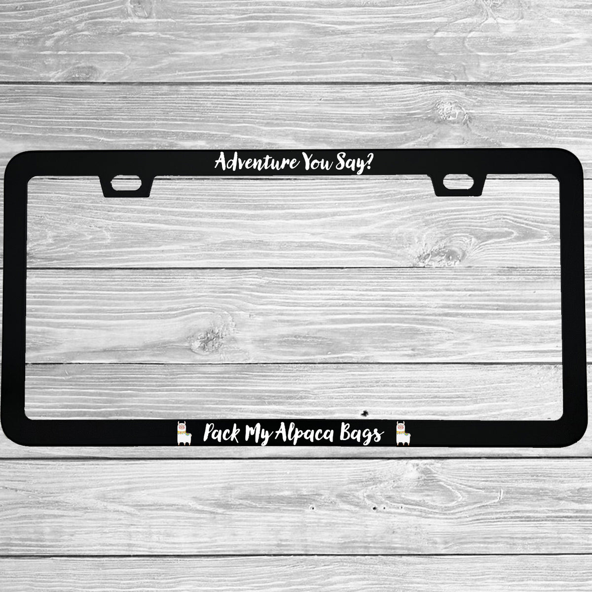 Close-up of "Adventure You Say Pack My Alpaca Bags" license plate frame showing fade-proof print quality