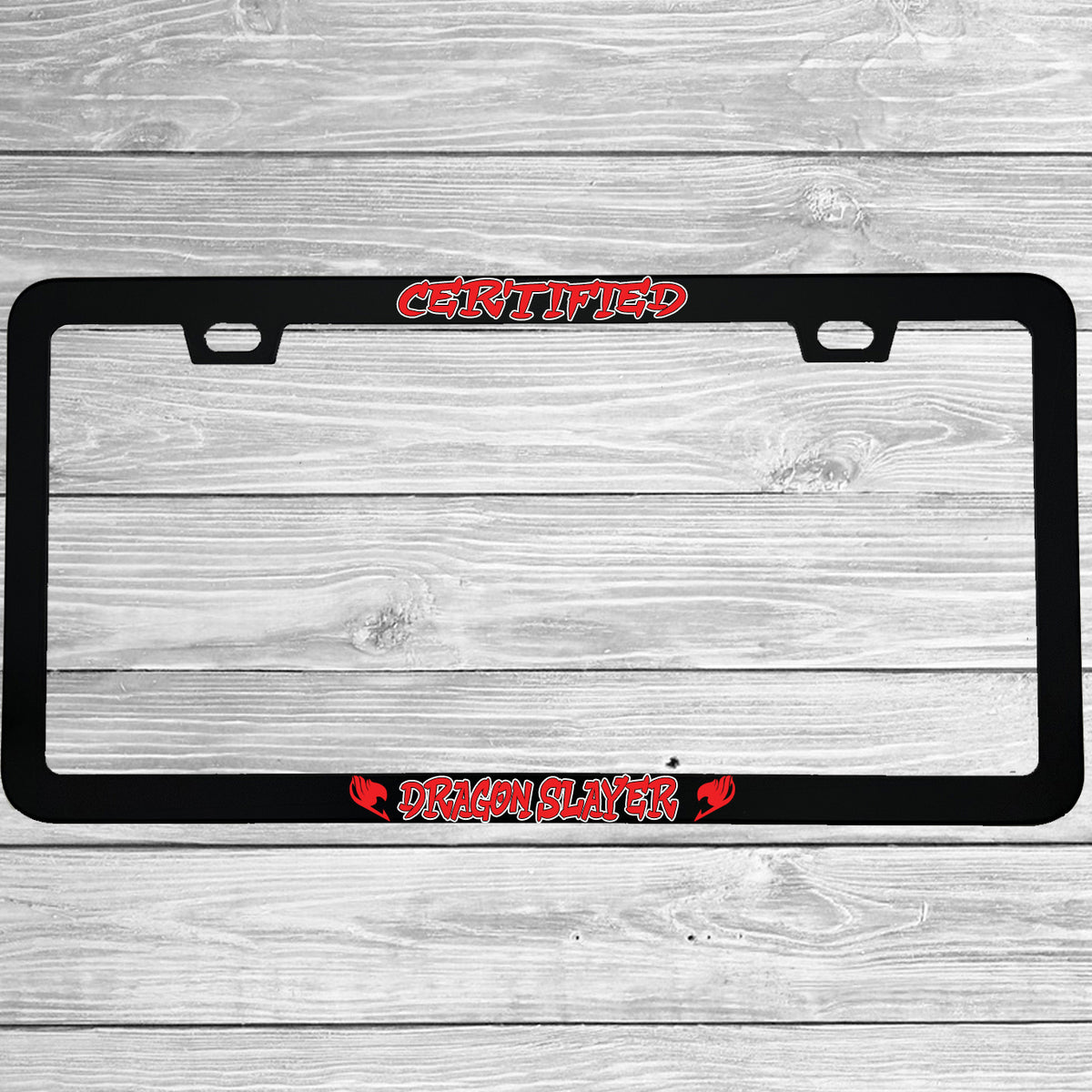 Close-up of "Certified Dragon Slayer" license plate frame showing fade-proof print quality