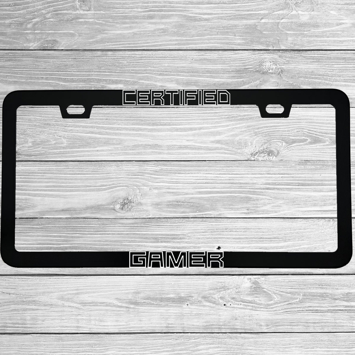 Close-up of "Certified Gamer" license plate frame showing fade-proof print quality