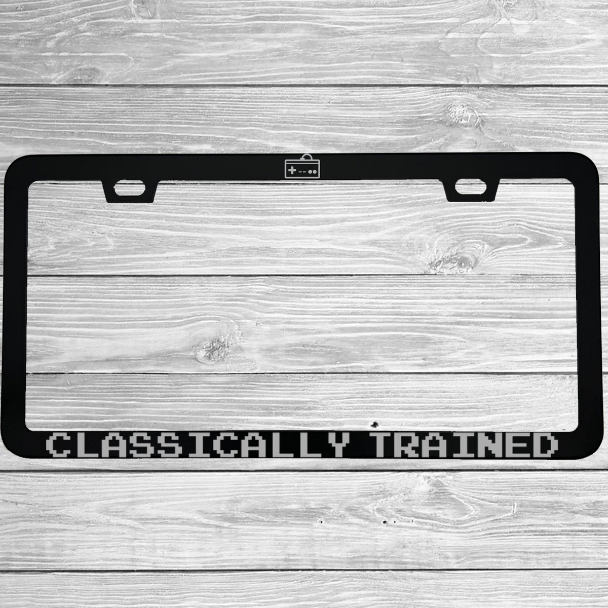 Close-up of "Classically Trained" license plate frame showing fade-proof print quality