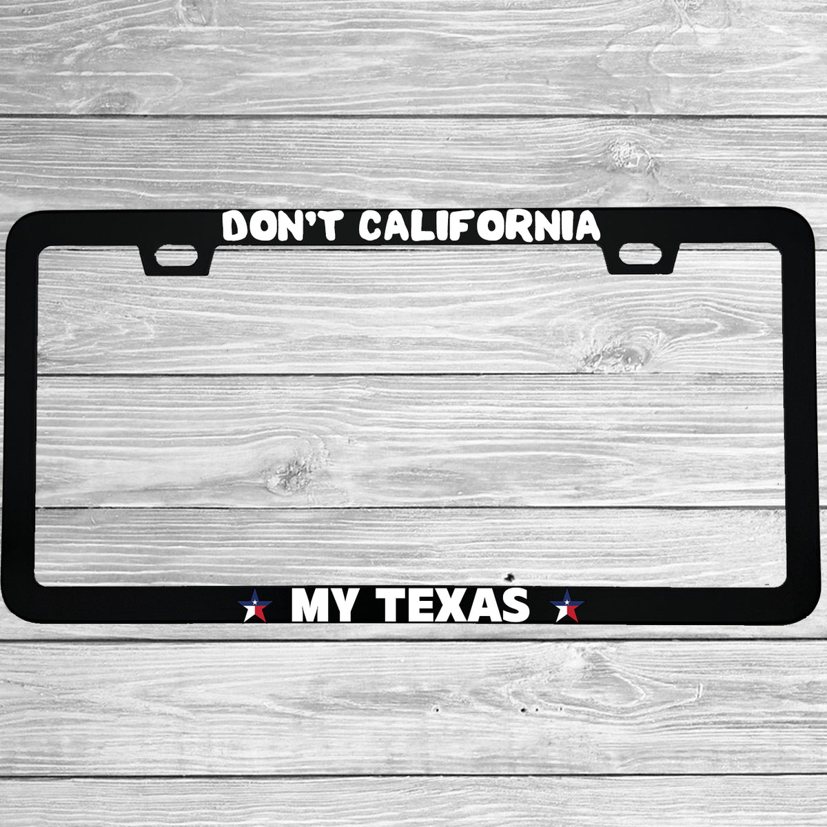 Close-up of "Don't California My Texas" license plate frame showing fade-proof print quality