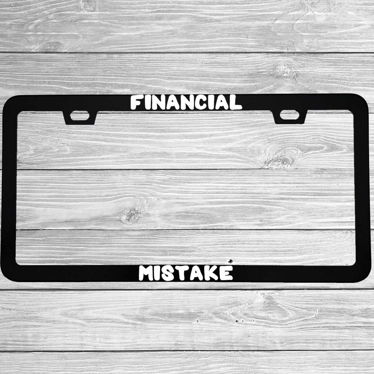 Close-up of "Financial Mistake" license plate frame showing fade-proof print quality