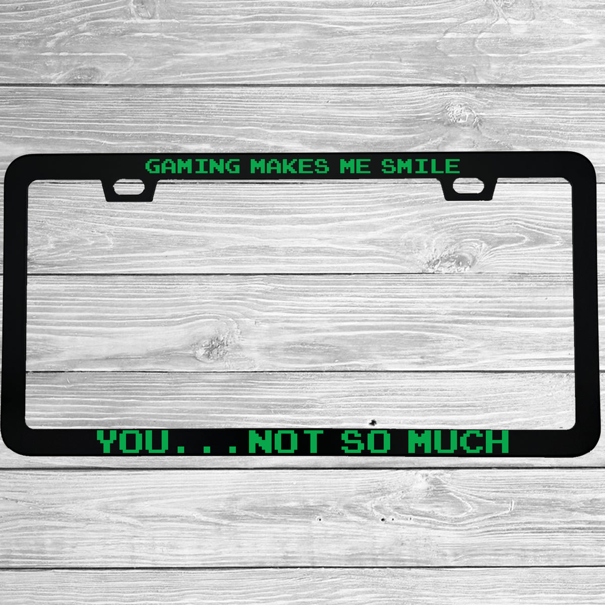 Close-up of "Gaming Makes Me Smile, You Not So Much" license plate frame showing fade-proof print quality
