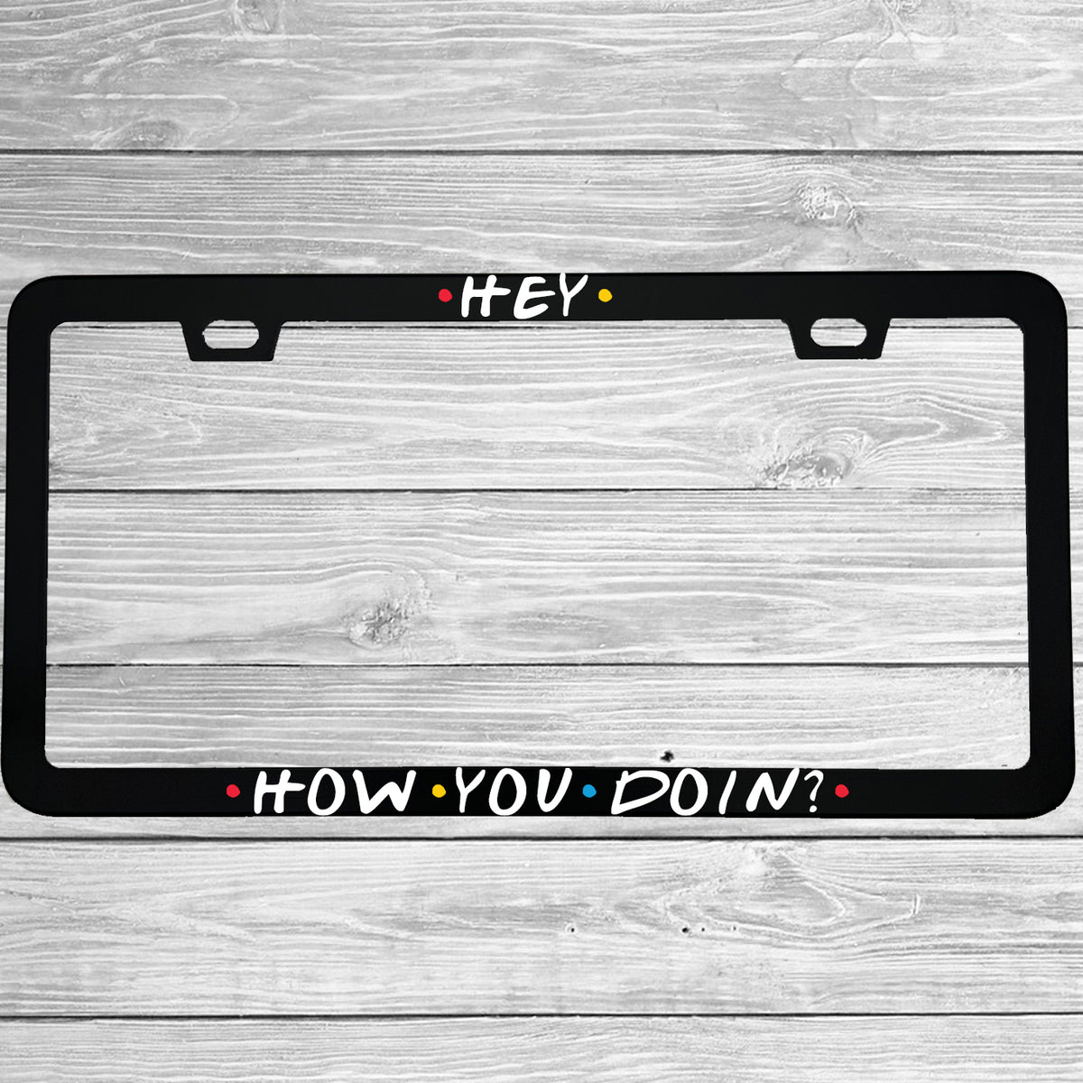 Close-up of "Hey How You Doin" license plate frame showing fade-proof print quality