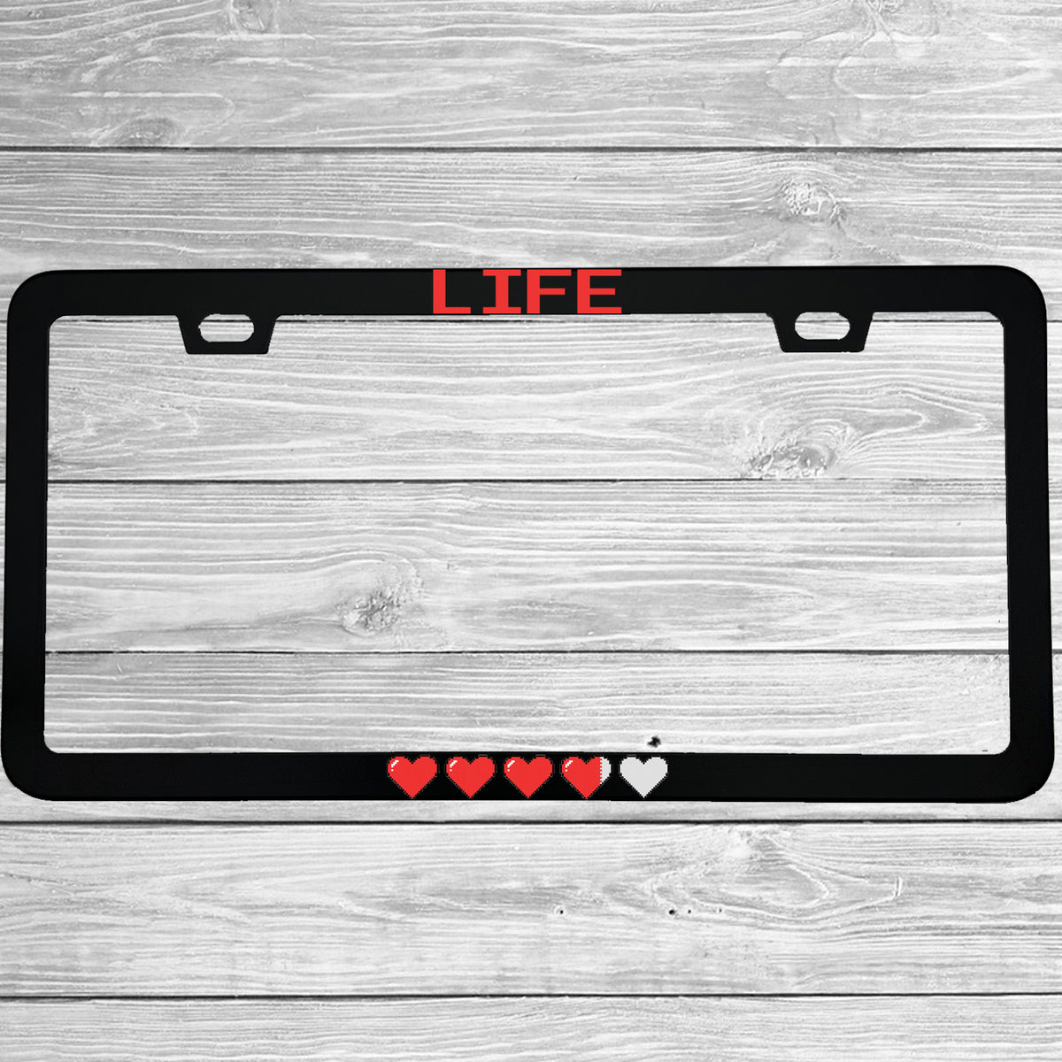 Close-up of "Life Pixel Hearts" license plate frame showing fade-proof print quality
