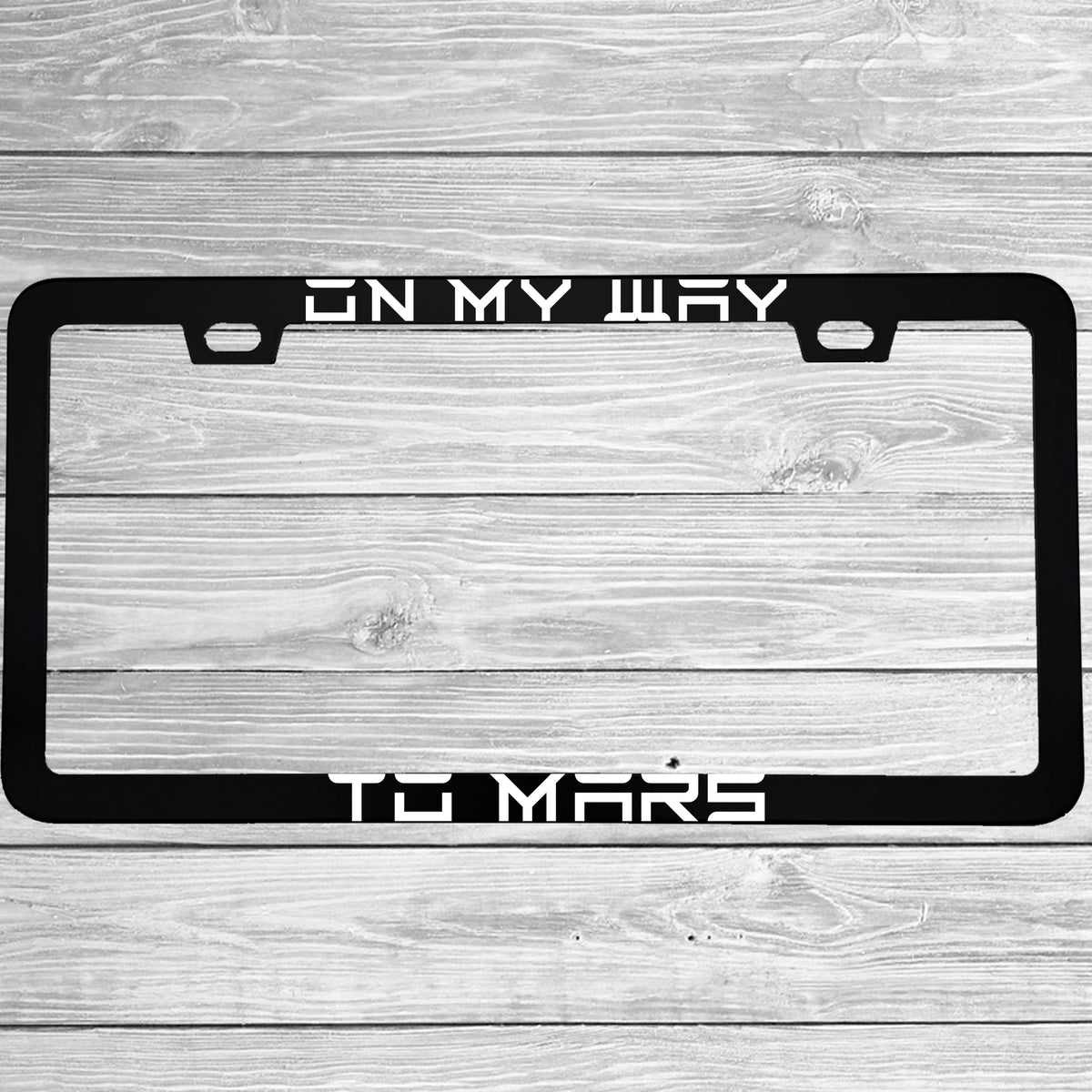 Close-up of "On My Way To Mars Funny Electric Car Outer Space Themed" license plate frame showing fade-proof print quality