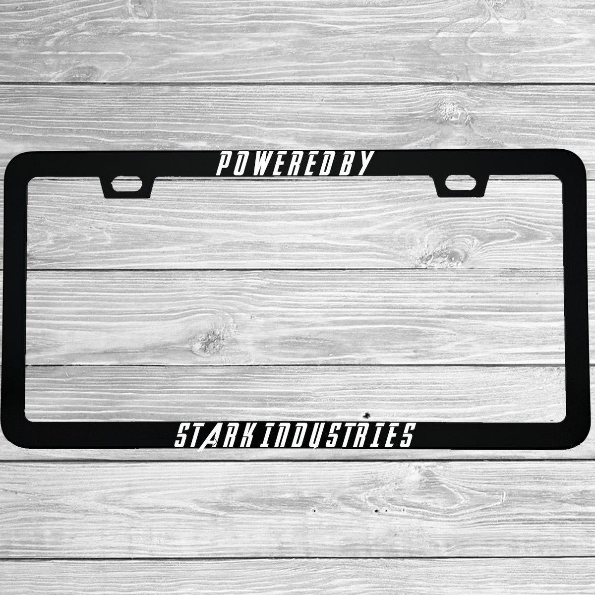 Close-up of "Powered By Stark Industries" license plate frame showing fade-proof print quality