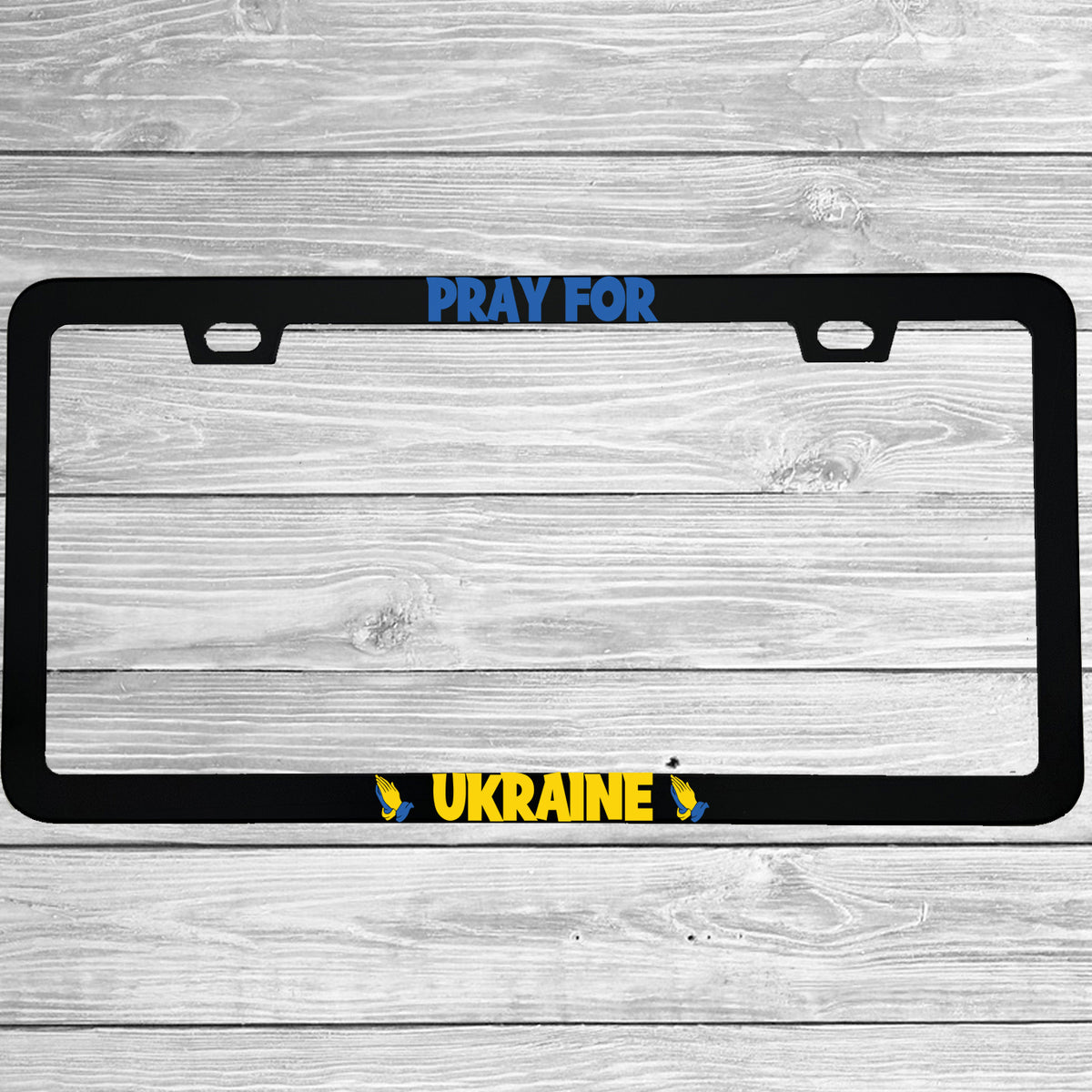 Close-up of "Pray For Ukraine" license plate frame showing fade-proof print quality