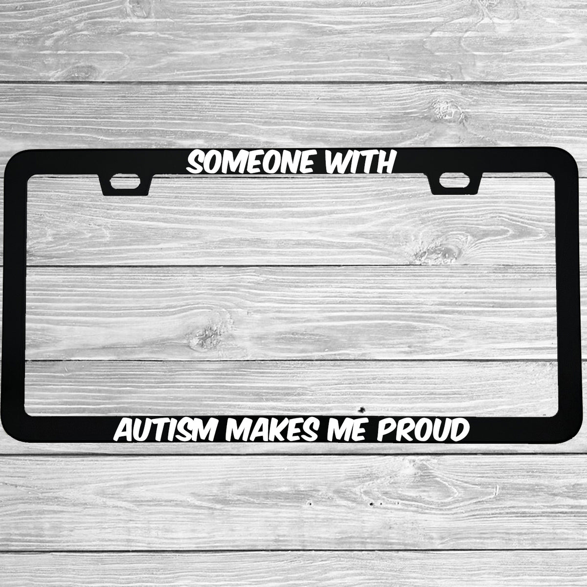 Close-up of "Someone With Autism Makes Me Proud" license plate frame showing fade-proof print quality