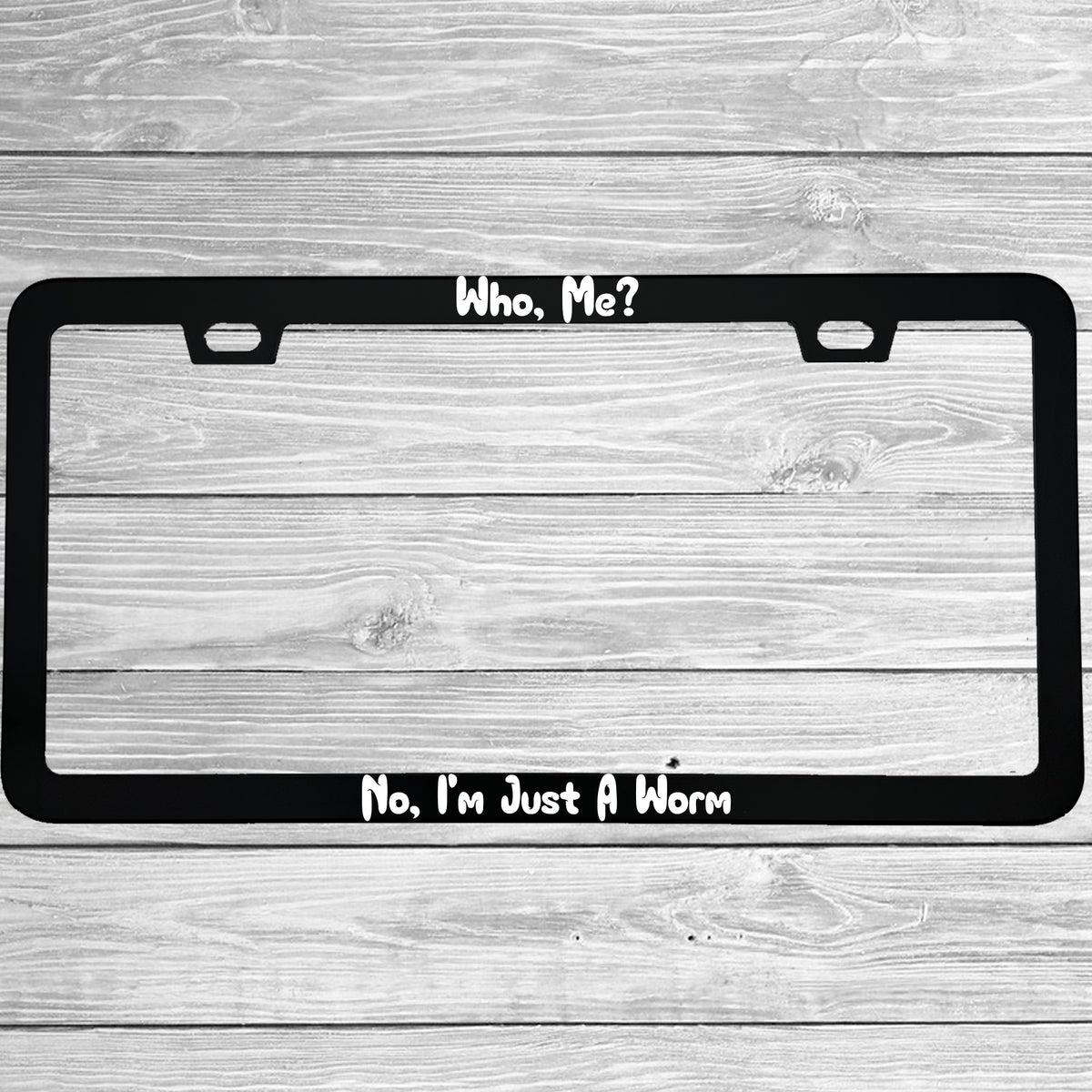 Close-up of "Who, Me?  No, I'm Just A Worm" license plate frame showing fade-proof print quality