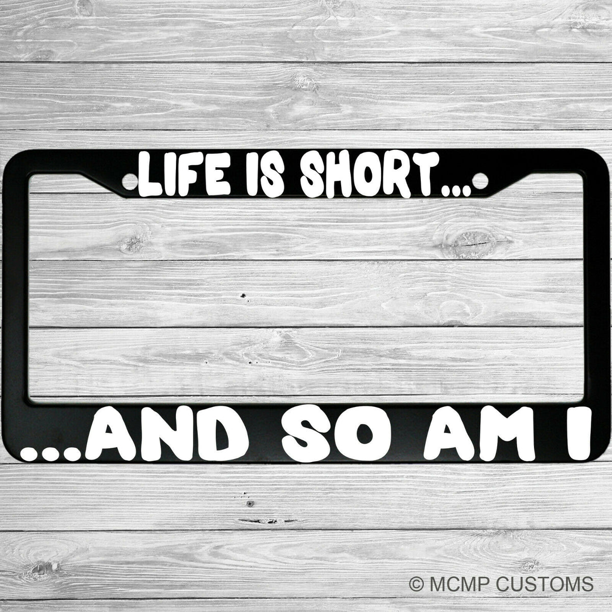 "Life Is Short And So Am I" license plate frame shown on vehicle — lifestyle photo