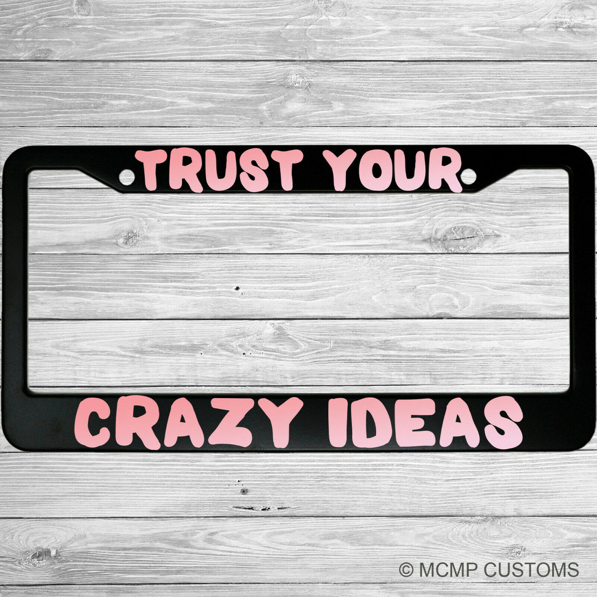"Trust Your Crazy Ideas" license plate frame shown on vehicle — lifestyle photo